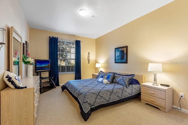 bedroom featuring light colored carpet