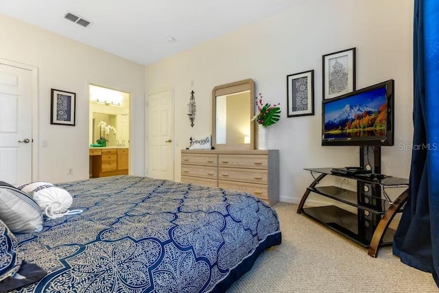 carpeted bedroom with connected bathroom