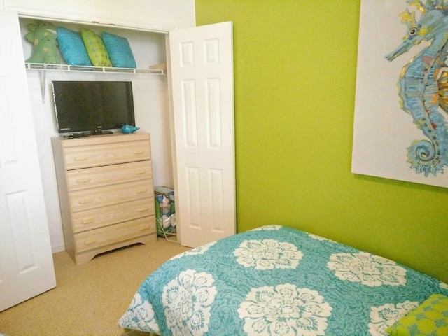 carpeted bedroom featuring a closet