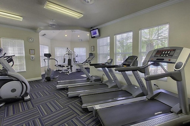 workout area featuring ceiling fan and ornamental molding