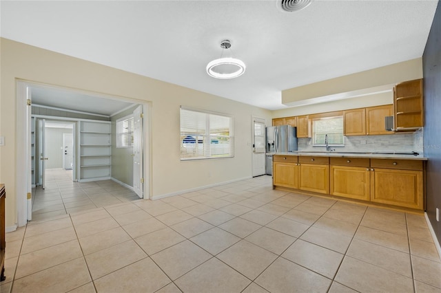 kitchen with decorative backsplash, stainless steel fridge with ice dispenser, and light tile patterned floors