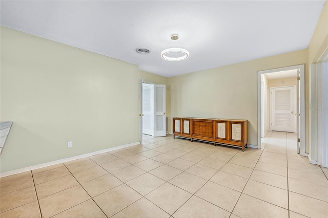 unfurnished room featuring light tile patterned floors