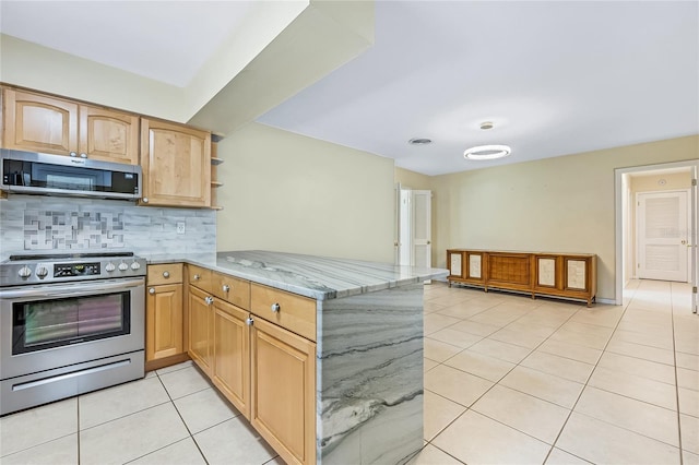 kitchen with light stone counters, backsplash, kitchen peninsula, light tile patterned floors, and appliances with stainless steel finishes