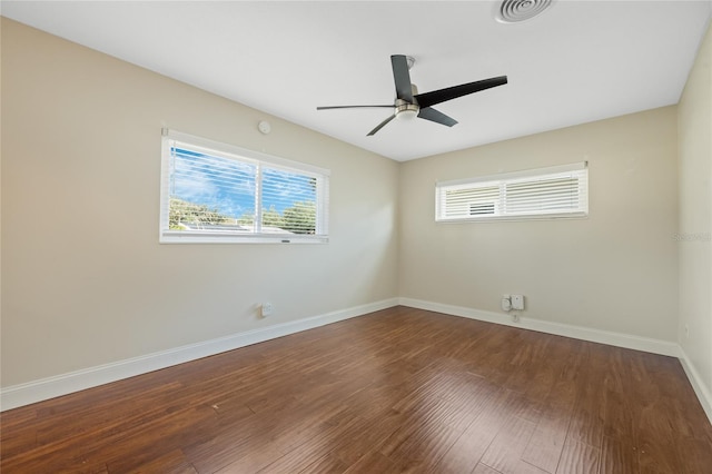 spare room featuring ceiling fan and dark hardwood / wood-style flooring