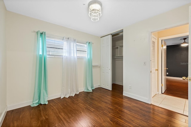 unfurnished bedroom featuring hardwood / wood-style floors and a closet