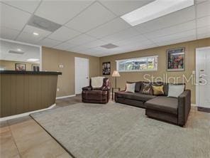 living room with a drop ceiling