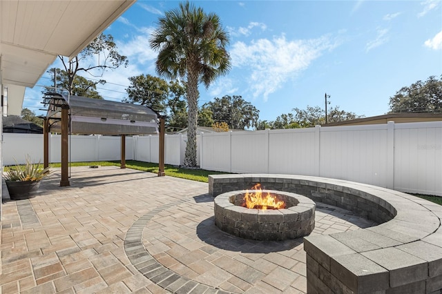 view of patio with a fire pit