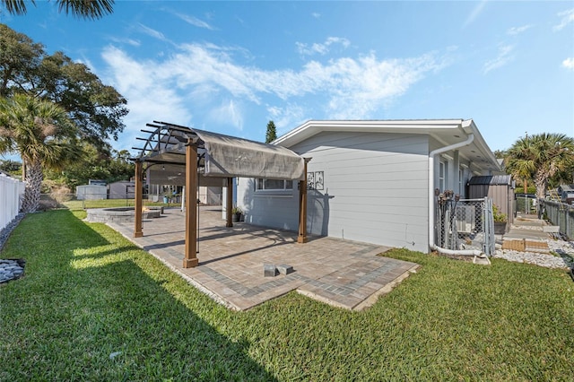 rear view of property with a lawn, a pergola, and a patio