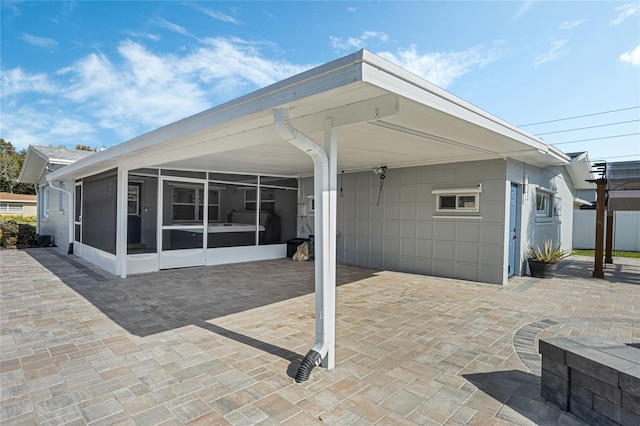 view of patio with a sunroom