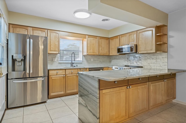 kitchen with kitchen peninsula, appliances with stainless steel finishes, backsplash, and sink