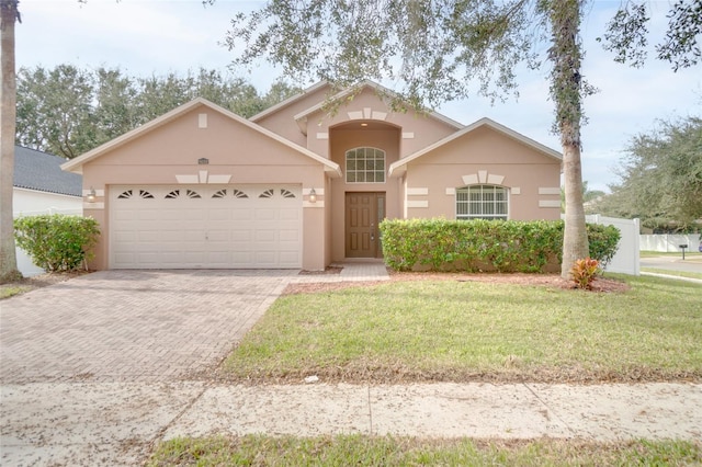 view of front of house featuring a garage and a front lawn