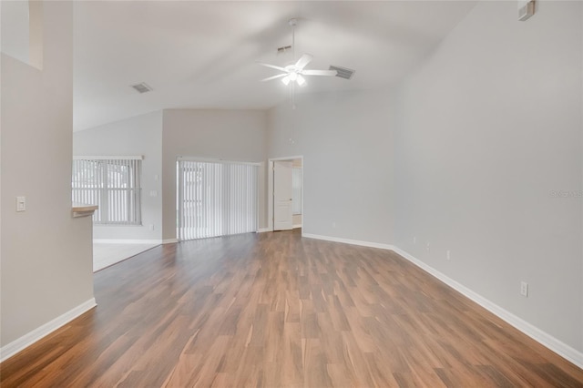 empty room with lofted ceiling, wood-type flooring, and ceiling fan