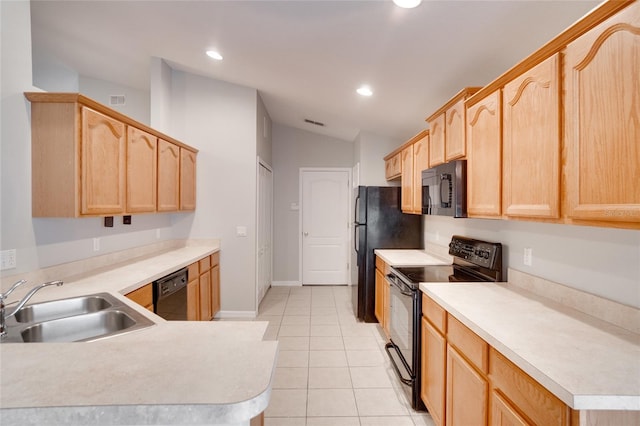 kitchen with vaulted ceiling, sink, light brown cabinetry, and black appliances