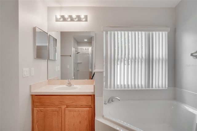 bathroom featuring vanity and shower with separate bathtub