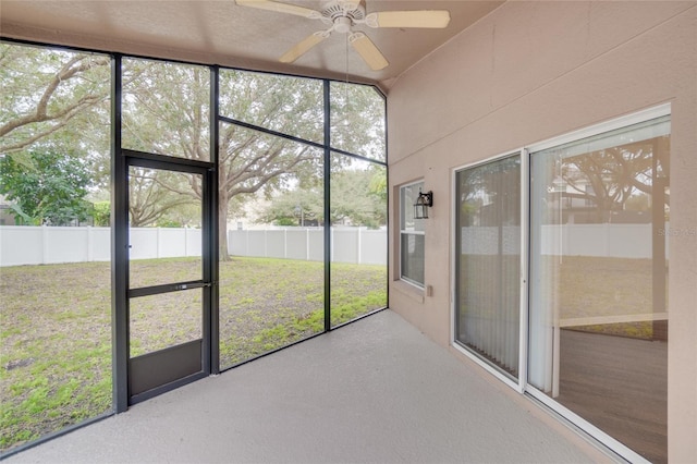 unfurnished sunroom featuring ceiling fan