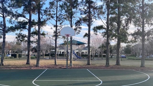 view of basketball court featuring a playground