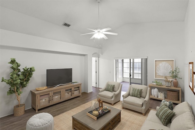 living room with hardwood / wood-style flooring, ceiling fan, and lofted ceiling