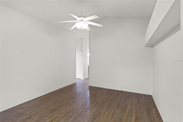 spare room with dark hardwood / wood-style floors, vaulted ceiling, and ceiling fan