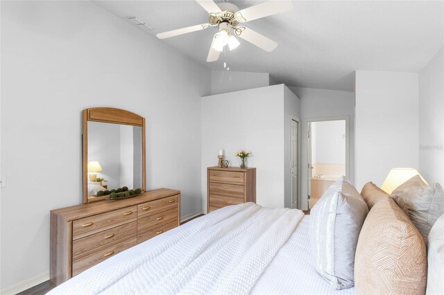 bedroom featuring connected bathroom, a closet, vaulted ceiling, and ceiling fan