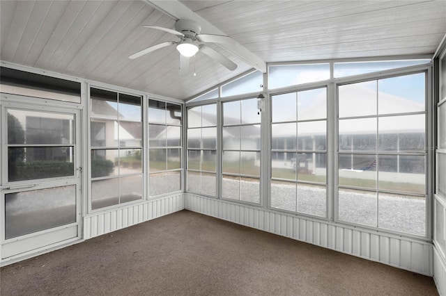 unfurnished sunroom with a wealth of natural light, vaulted ceiling with beams, and ceiling fan