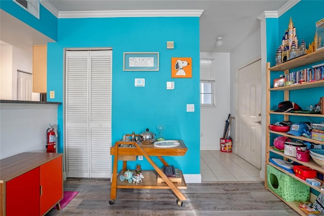 interior space with tile patterned floors and crown molding