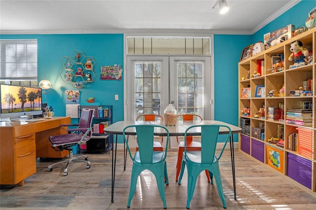 dining area featuring hardwood / wood-style flooring and crown molding