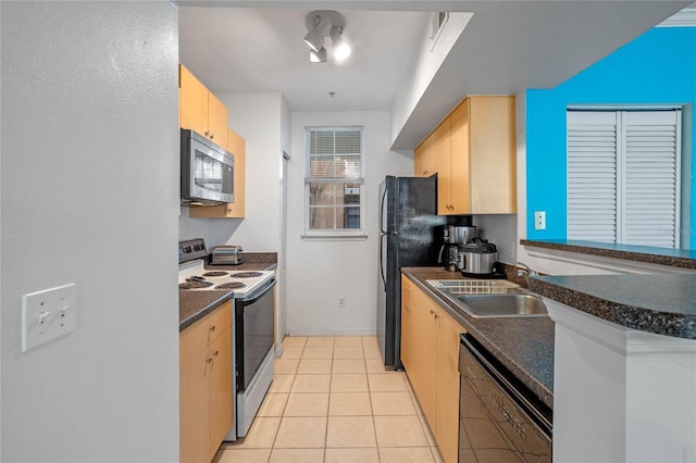 kitchen with light brown cabinets, electric stove, sink, light tile patterned floors, and black dishwasher