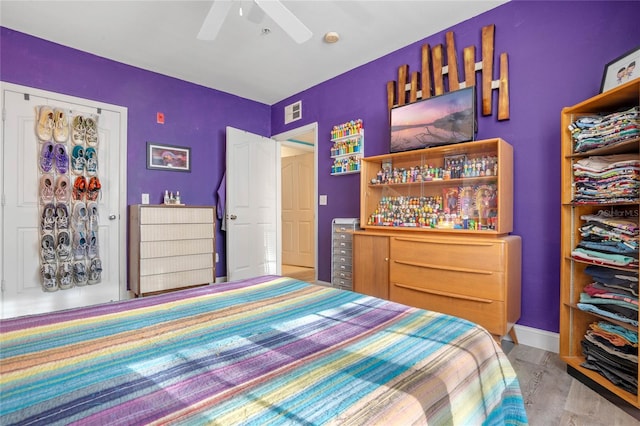 bedroom featuring ceiling fan and light wood-type flooring