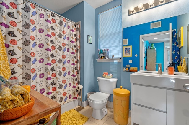 bathroom with tile patterned floors, vanity, and toilet