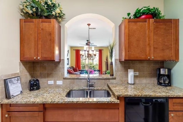 kitchen with dishwasher, tasteful backsplash, light stone countertops, and sink