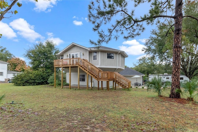 rear view of house featuring a yard and a wooden deck