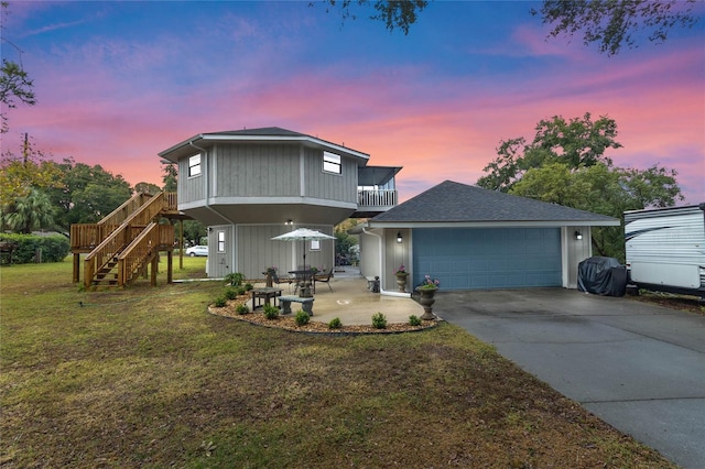 view of property with a lawn and a balcony