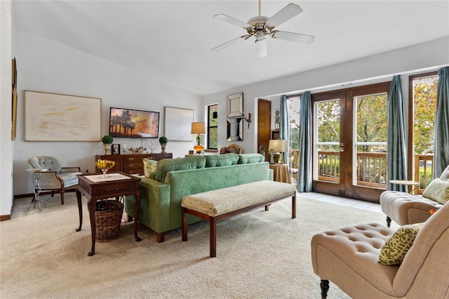 living room featuring light colored carpet, vaulted ceiling, a wealth of natural light, and ceiling fan