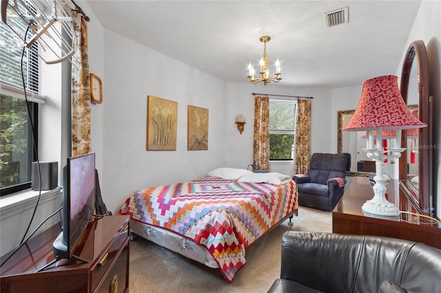 bedroom with carpet and an inviting chandelier