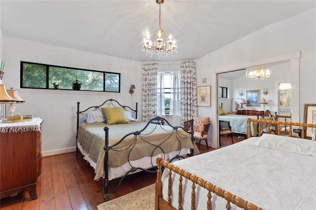 bedroom featuring lofted ceiling, dark hardwood / wood-style floors, and a notable chandelier