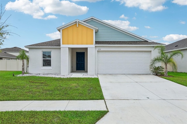 view of front facade with a front yard and a garage