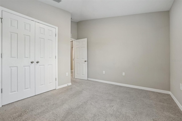 unfurnished bedroom featuring a closet and carpet floors