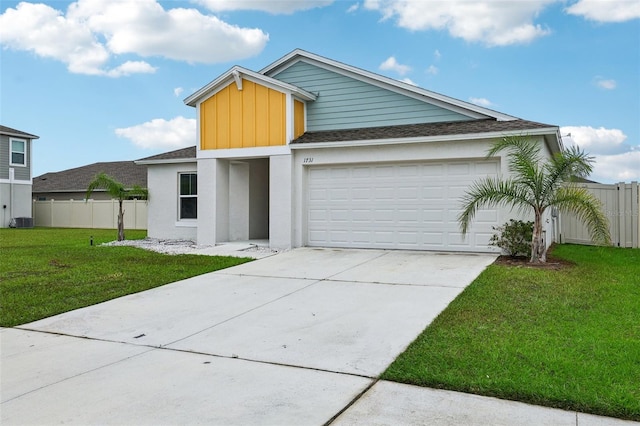 view of front facade featuring cooling unit, a garage, and a front lawn