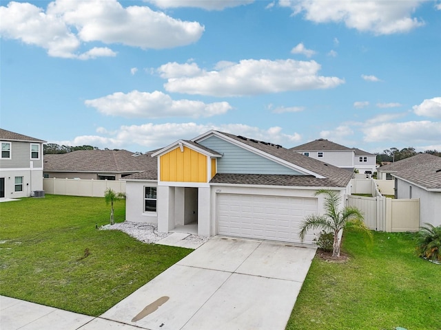 view of front of property with central AC, a front yard, and a garage