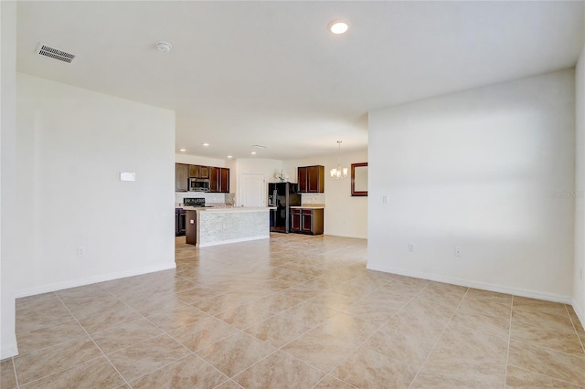 unfurnished living room featuring light tile patterned floors and a chandelier