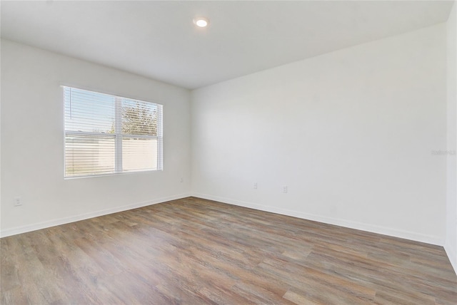 unfurnished room with hardwood / wood-style floors