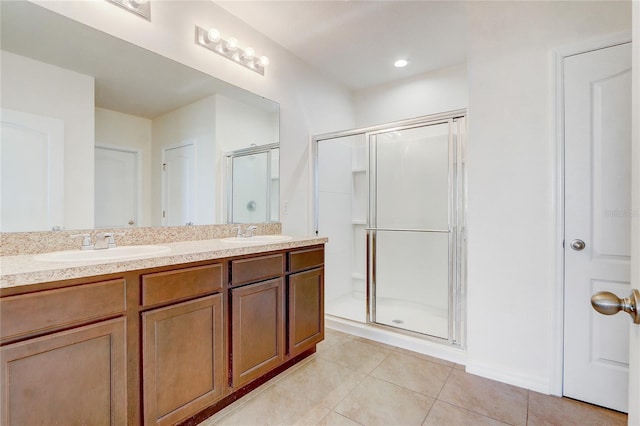 bathroom with tile patterned flooring, vanity, and an enclosed shower