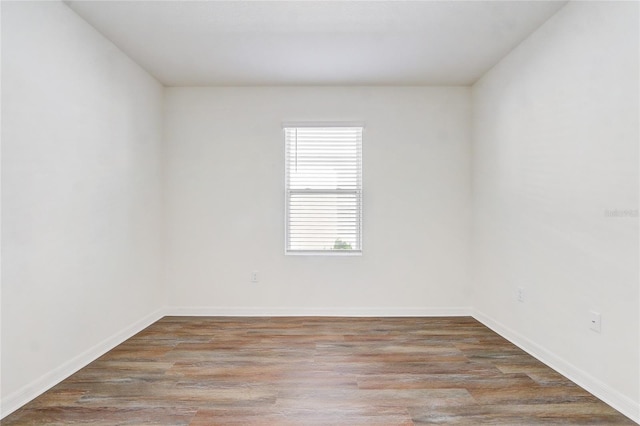 unfurnished room with hardwood / wood-style flooring