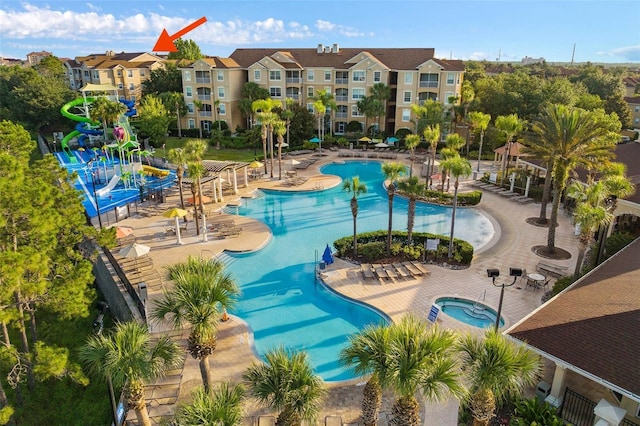 view of pool with a patio and a hot tub