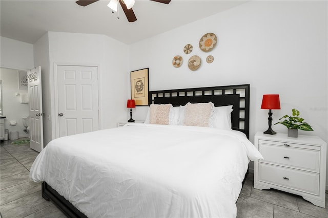 bedroom with ceiling fan, light tile patterned floors, ensuite bathroom, and a closet