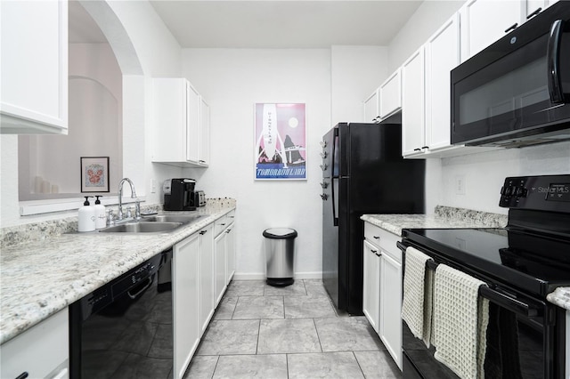 kitchen featuring light stone counters, sink, black appliances, light tile patterned floors, and white cabinets