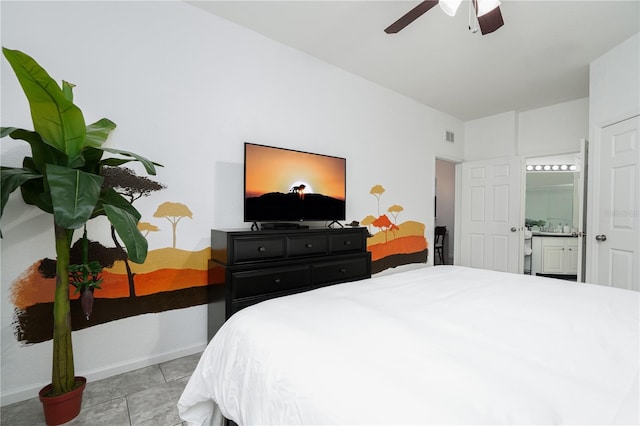 tiled bedroom with ceiling fan and ensuite bathroom