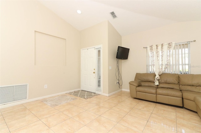 unfurnished living room featuring light tile patterned floors and lofted ceiling