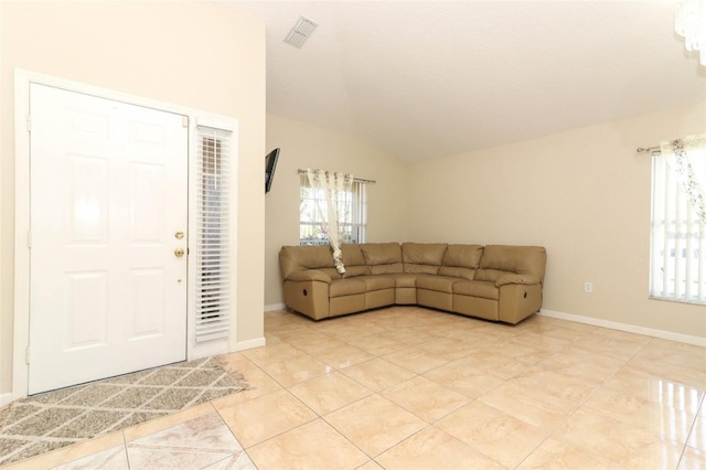 tiled living room with lofted ceiling