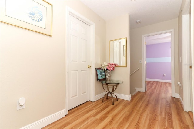 hallway with light hardwood / wood-style flooring